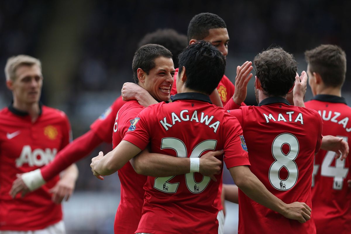 Manchester United's Mexican striker Javier Hernandez (L) and Manchester United's Japanese midfielder Shinji Kagawa (C) celebrates after Manchester United's Spanish midfielder Juan Mata scored during the English Premier League football match between Newcastle United and Manchester United at St James' Park in Newcastle Upon Tyne, northeast England on April 5, 2014. Manchester United won 4-0.  AFP PHOTO / IAN MACNICOL 

RESTRICTED TO EDITORIAL USE. No use with unauthorized audio, video, data, fixture lists, club/league logos or live services. Online in-match use limited to 45 images, no video emulation. No use in betting, games or single club/league/player publications.        (Photo credit should read Ian MacNicol/AFP via Getty Images)