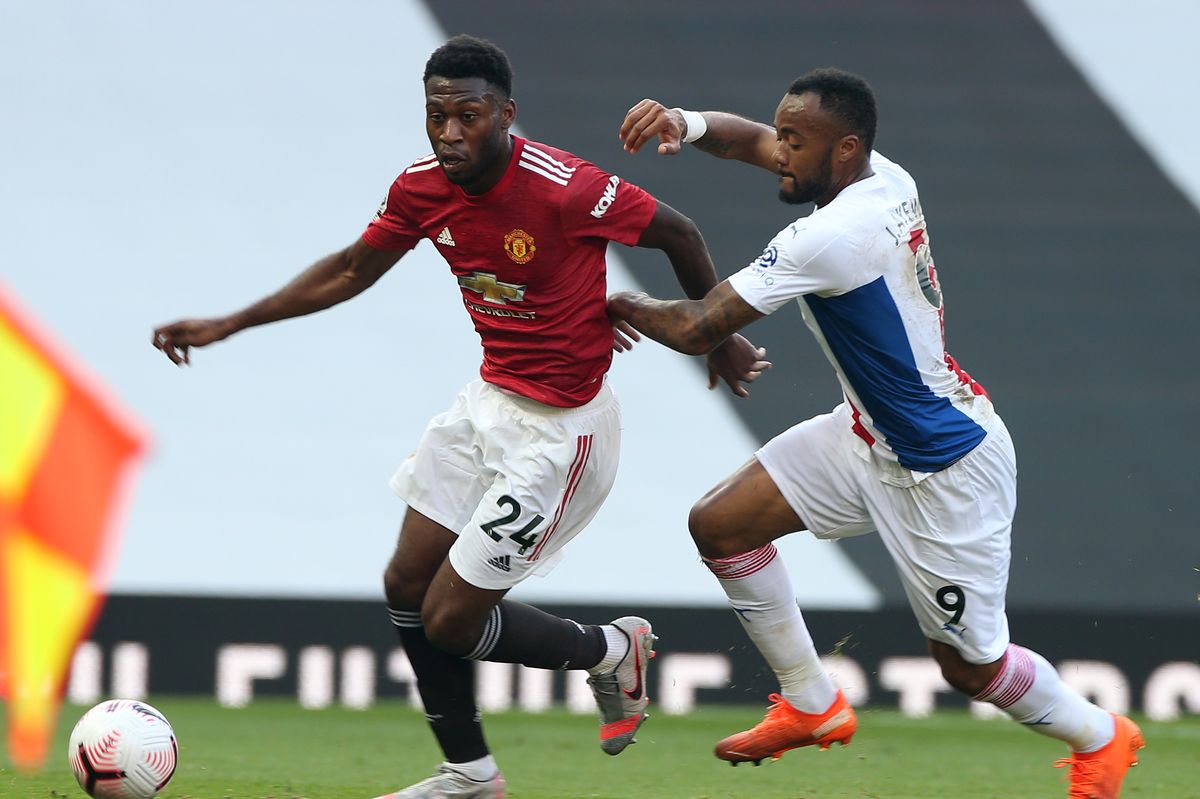 MANCHESTER, ENGLAND - SEPTEMBER 19: Timothy Fosu-Mensahof Manchester United in action with Jordan Ayew of Crystal Palace during the Premier League match between Manchester United and Crystal Palace at Old Trafford on September 19, 2020 in Manchester, England. (Photo by Matthew Peters/Manchester United via Getty Images)