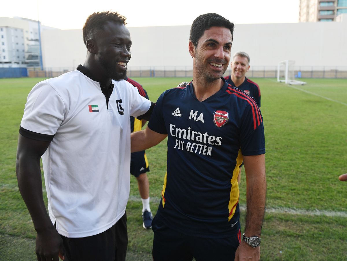 Arsenal manager Mikel Arteta with ex player Bacary Sagna after a training session at Al Nasr Leisure Land Stadium on December 12, 2022 in Dubai, United Arab Emirates. 