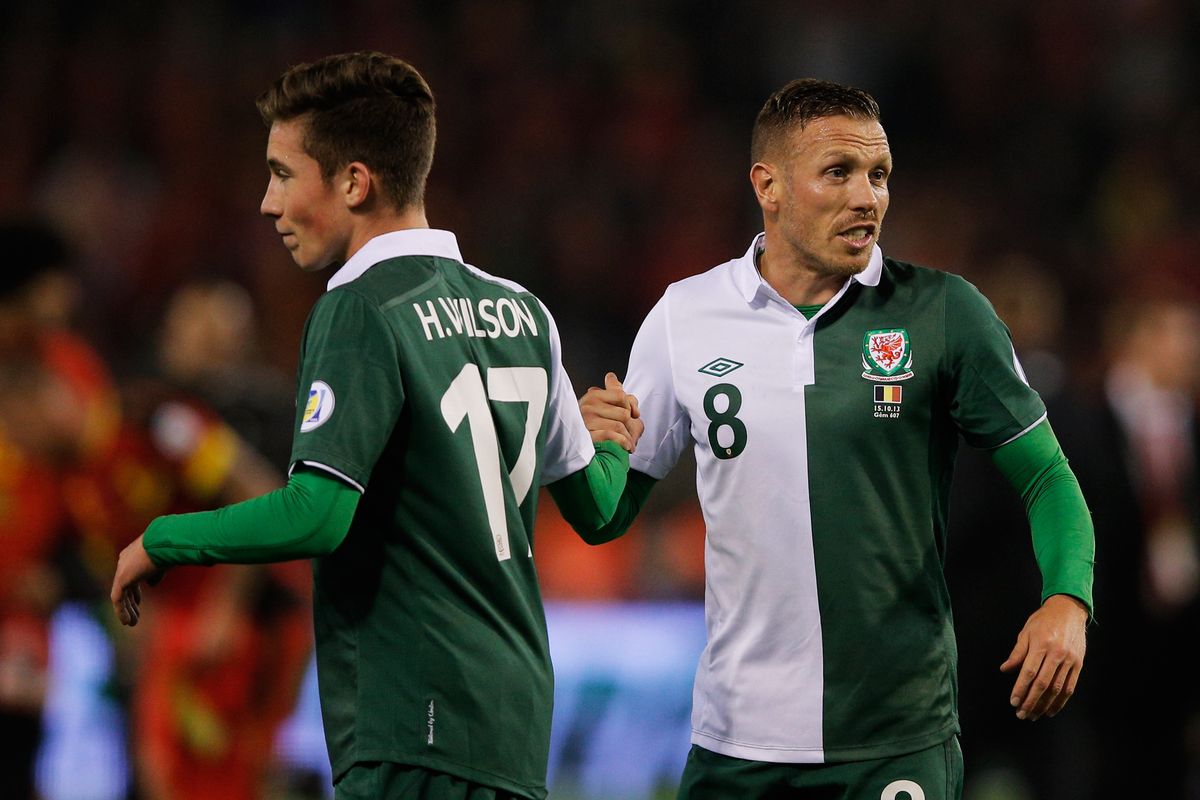 Craig Bellamy (R) and Harry Wilson of Wales shake hands after the FIFA 2014 World Cup Qualifying Group A match between Belgium and Wales at King Baudouin Stadium on October 15, 2013 in Brussels, Belgium