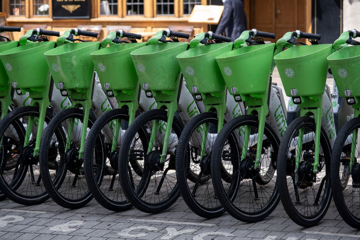 Lime electric bicycles parked carefully in a straight line on the pavement
