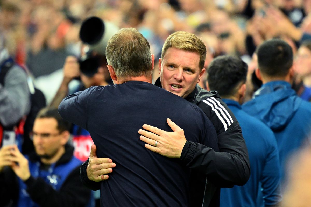 Eddie Howe, Manager of Newcastle United, embraces Hansi Flick, Head Coach of FC Barcelona