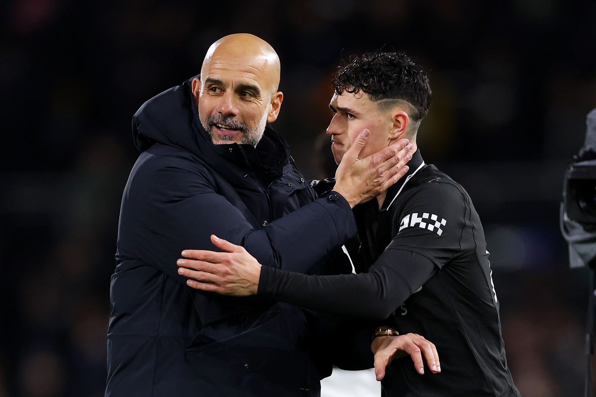 Pep Guardiola, manager of Manchester City, embraces Phil Foden of Manchester City after the team's victory in the Premier League match between Fulham and Manchester City at Craven Cottage 