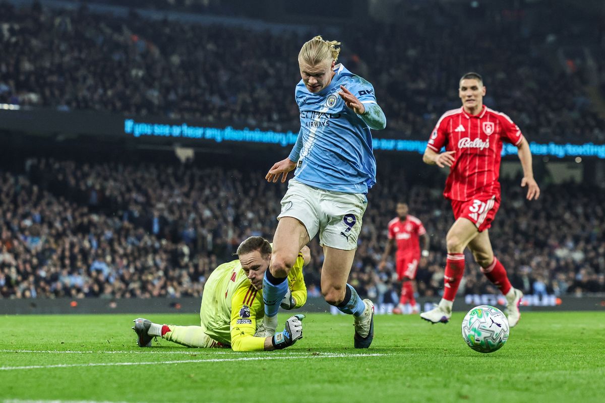 Erling Haaland goes down after a challenge from Nottingham Forest goalkeeper Matz Sels