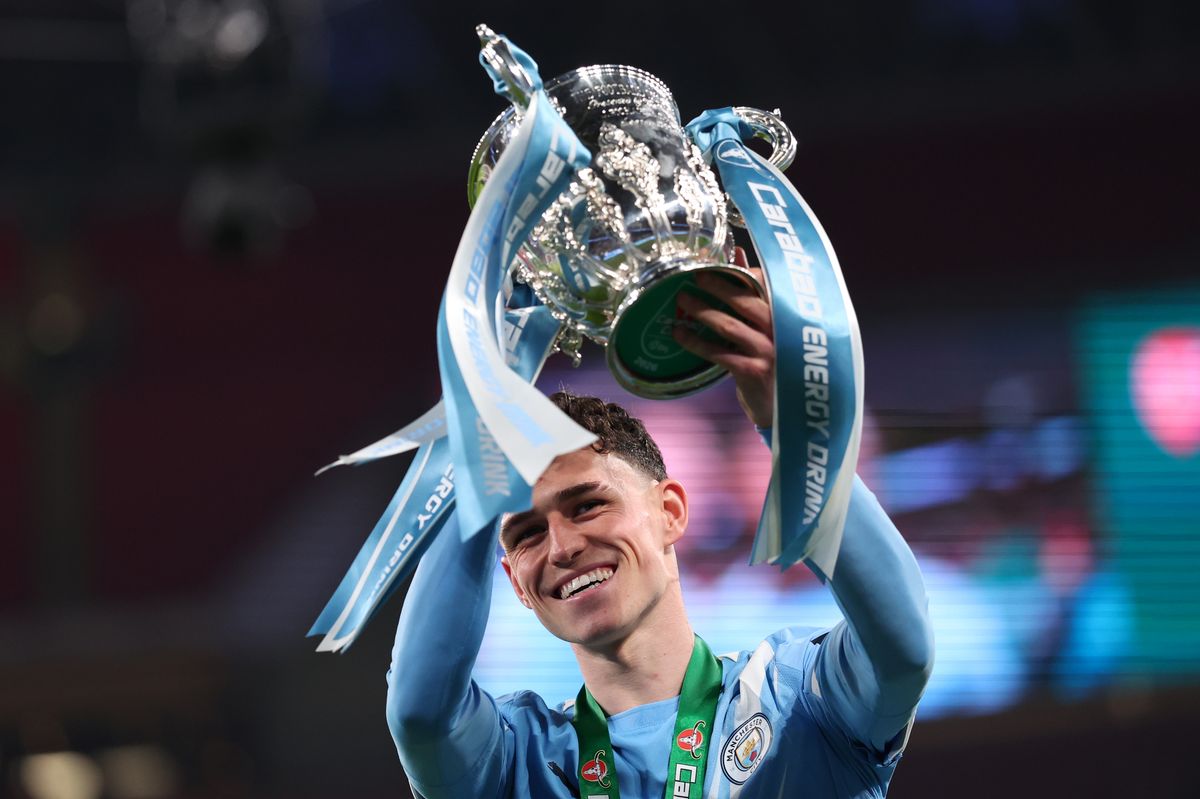 Phil Foden of Manchester City  celebrates with the trophy after the Carabao Cup Final match Arsenal and between Manchester City at Wembley Stadium