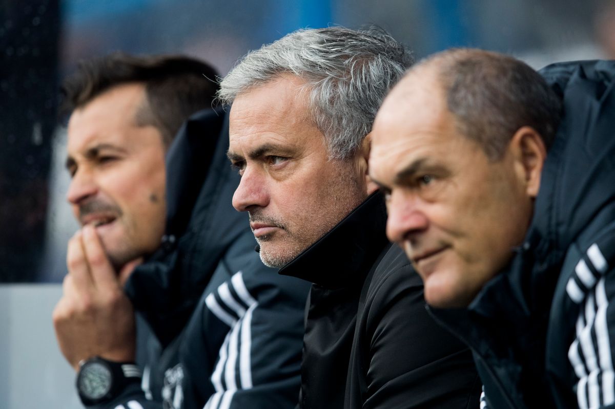 Jose Mourinho (C) looks on next to his assistants Rui Faria (L) and Silvino Louro