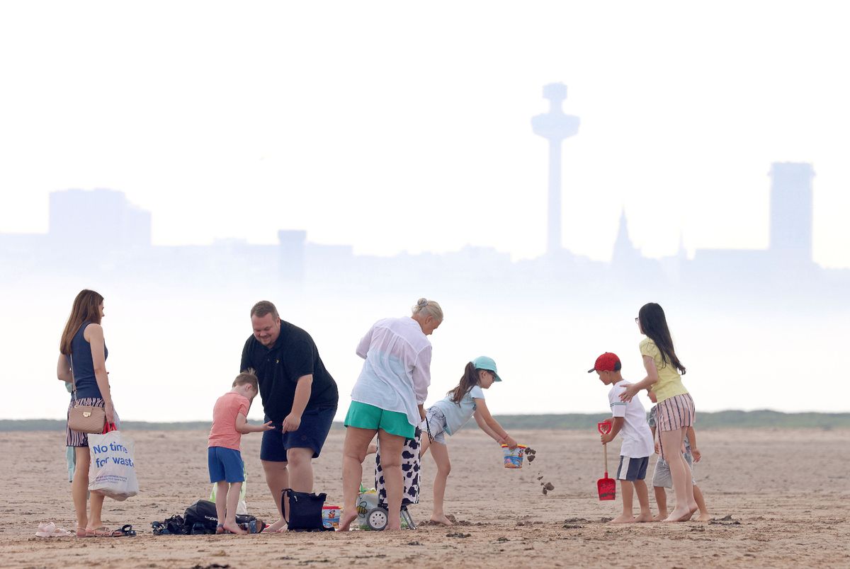 People out and about in the hot weather on New Brighton beach.