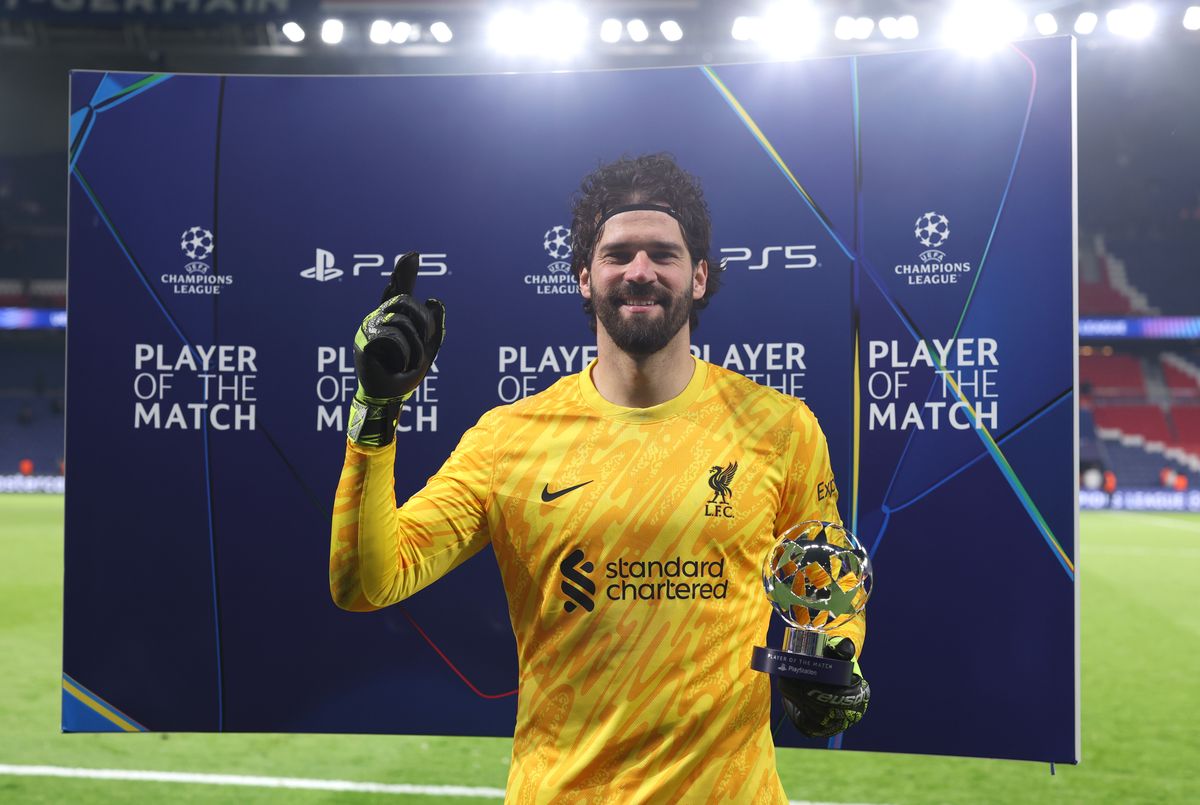 Alisson Becker receives the Player Of The Match award against PSG