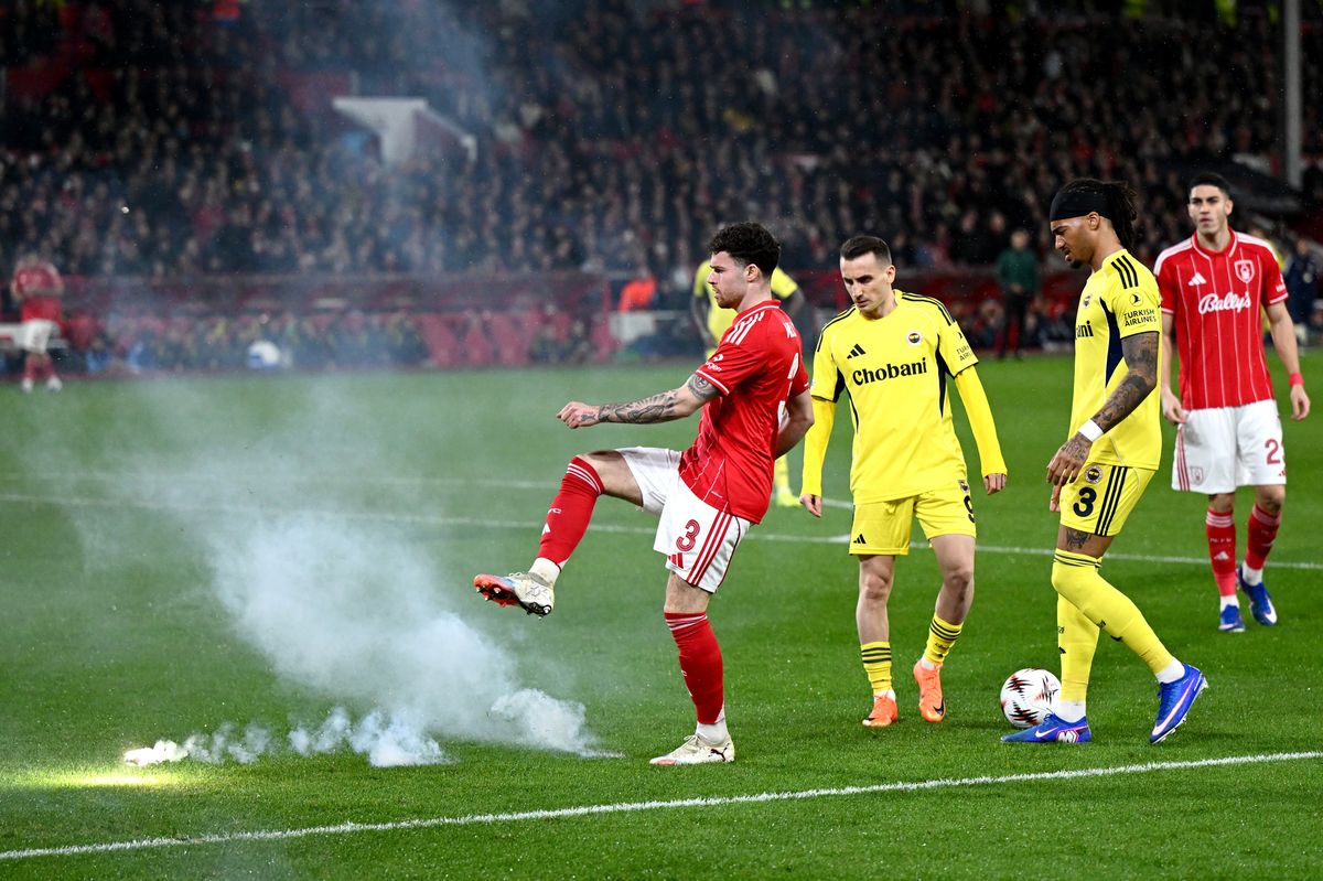 Nottingham Forest defender Neco Williams kicks away a flare during the Europa League clash with Fenerbahce at the City Ground