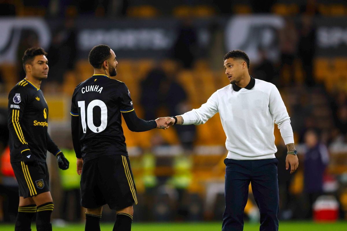 Joao Gomes of Wolverhampton Wanderers (R) greets fellow Brazilian players Matheus Cunha and Casemiro of Manchester United following the Premier League match between Wolverhampton Wanderers and Manchester United at Molineux on December 08, 2025 in Wolverhampton, England.