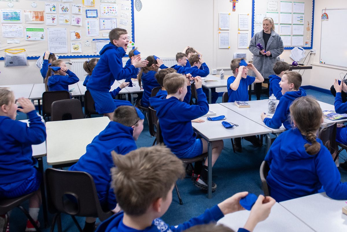 The footballer spoke to a group of children at Much Woolton Primary School