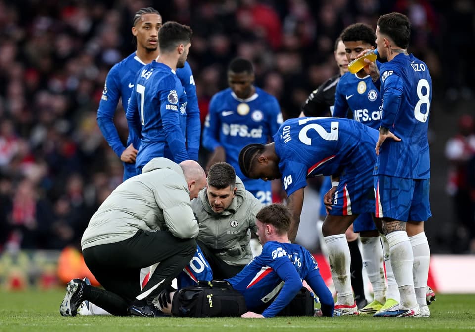 Cole Palmer receives treatment during Chelsea's defeat by Arsenal