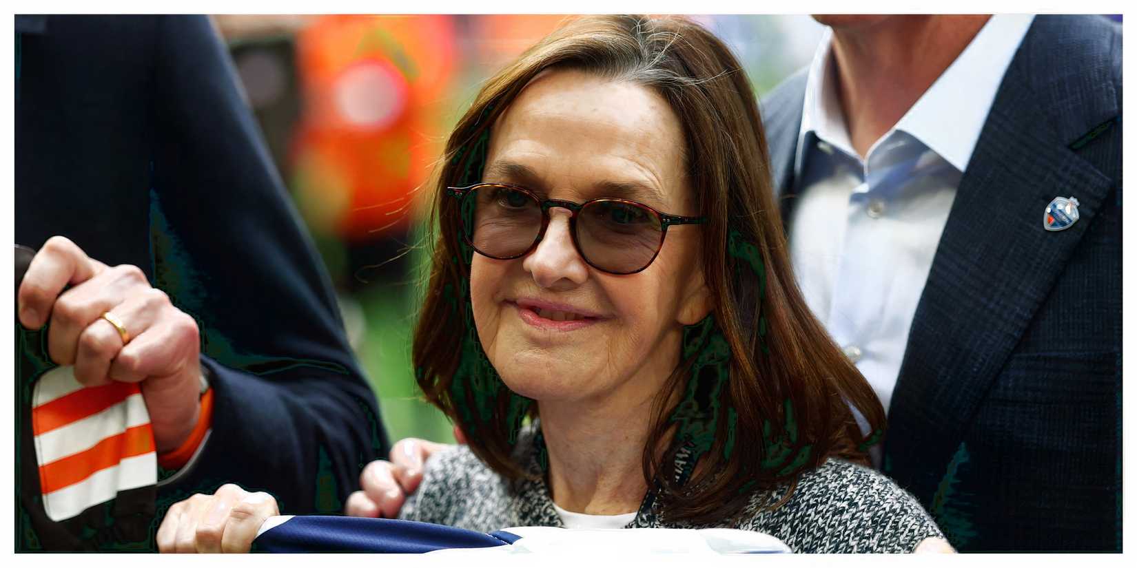 Vivienne Lewis holds up a Tottenham shirt