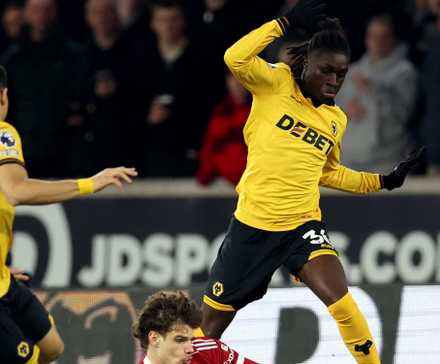 Liverpool's Milos Kerkez in action with Wolverhampton Wanderers' Mateus Mane and Andre 