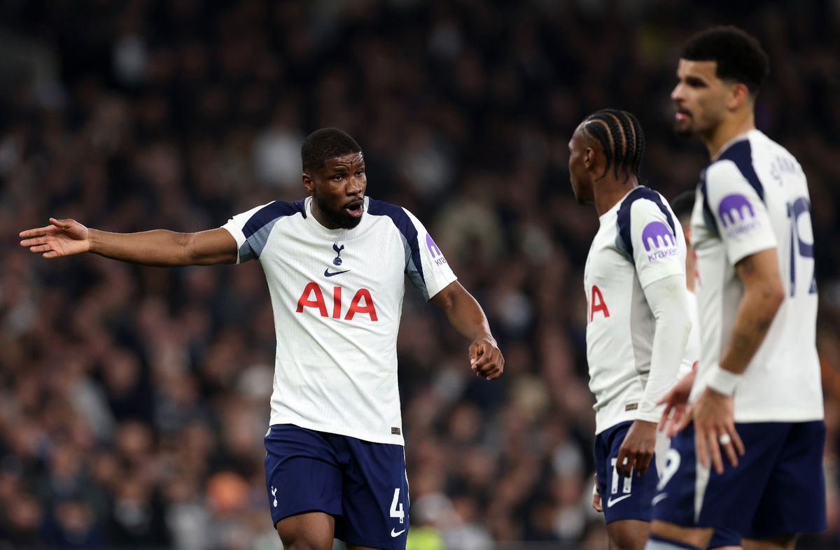 Kevin Danso of Tottenham Hotspur interacts with teammates