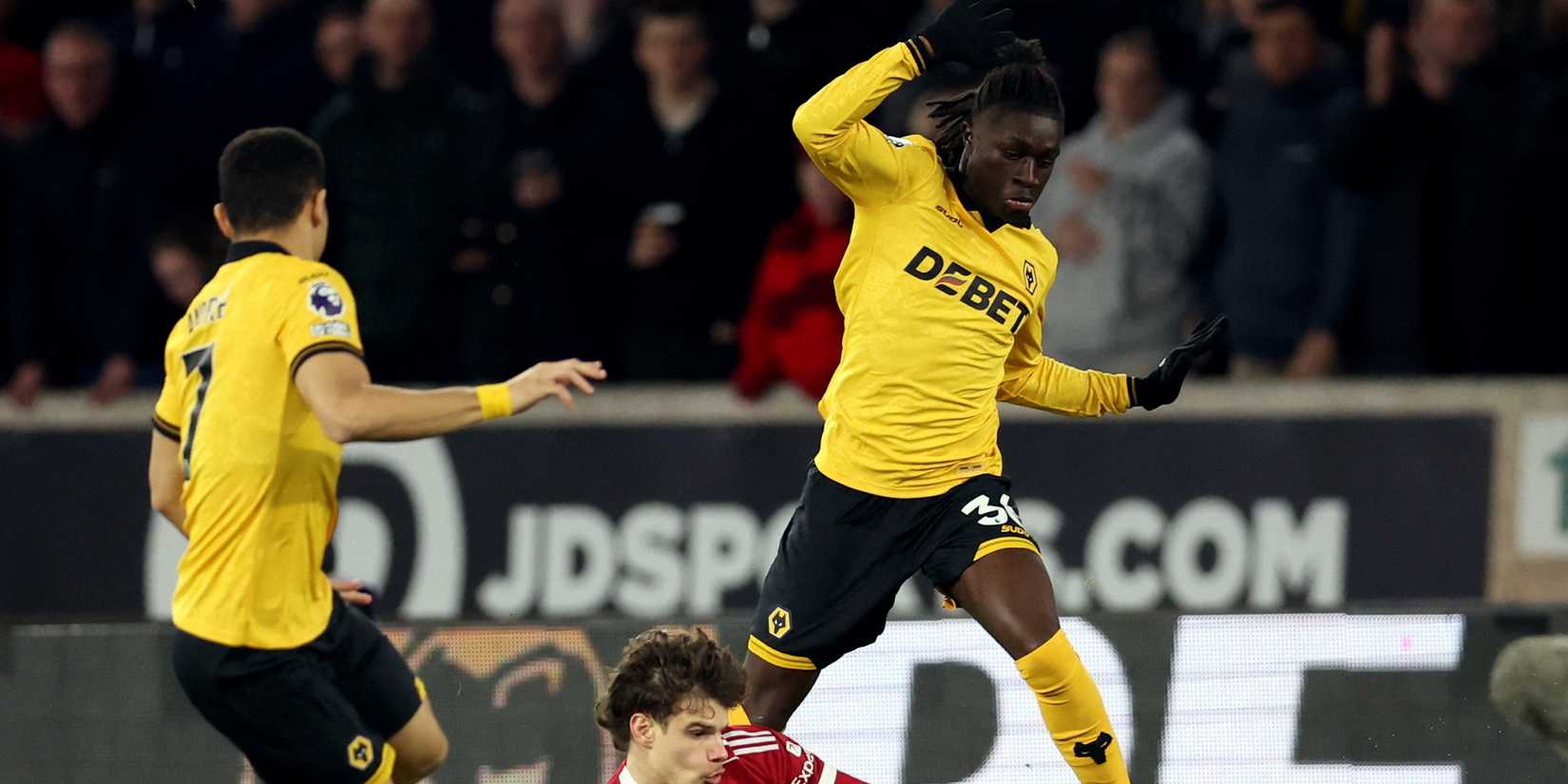 Liverpool's Milos Kerkez in action with Wolverhampton Wanderers' Mateus Mane and Andre 
