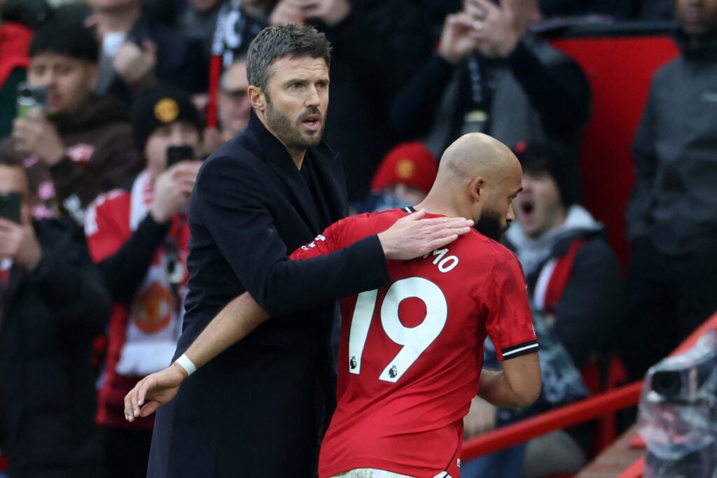 Michael Carrick with Bryan Mbeumo during the Premier League match between Manchester United and Manchester City at Old Trafford in Manchester, England, in 2026.