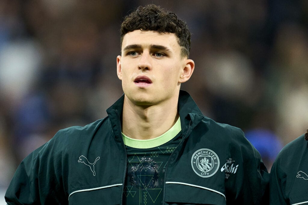 Phil Foden wearing a Man City training jacket