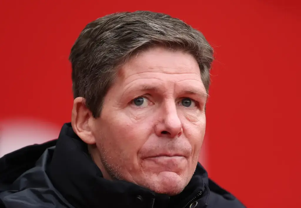 Oliver Glasner looks on during a Crystal Palace game with a concerned expression