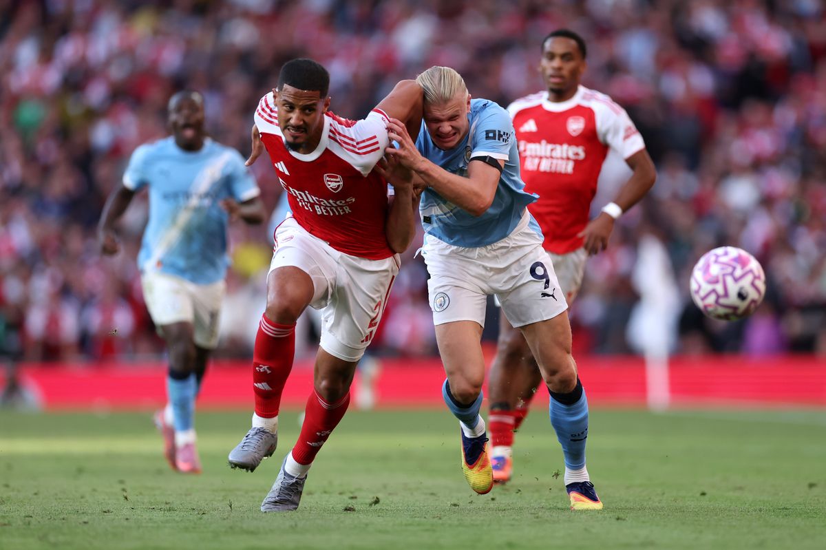 William Saliba of Arsenal battles for possession with Erling Haaland of Manchester City during the Premier League match between Arsenal and Manchester City at Emirates Stadium on September 21, 2025 in London, England. 