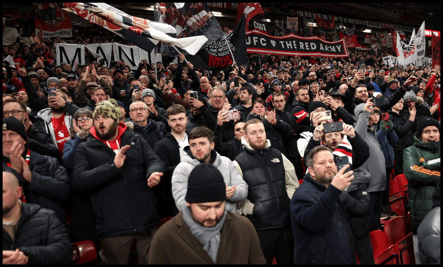 MANCHESTER, ENGLAND - NOVEMBER 24: Fans of Manchester United show their support prior to the Premier League match between Manchester United and Everton at Old Trafford on November 24, 2025 in Manchester, England.