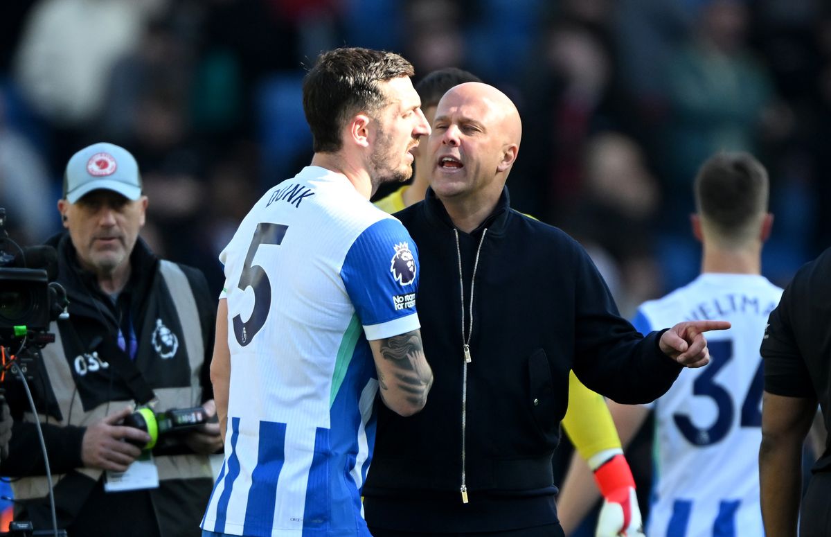 Arne Slot, Manager of Liverpool, reacts towards Lewis Dunk of Brighton & Hove Albion following the Premier League match between Brighton & Hove Albion and Liverpool at Amex Stadium on March 21, 2026 in Brighton, England