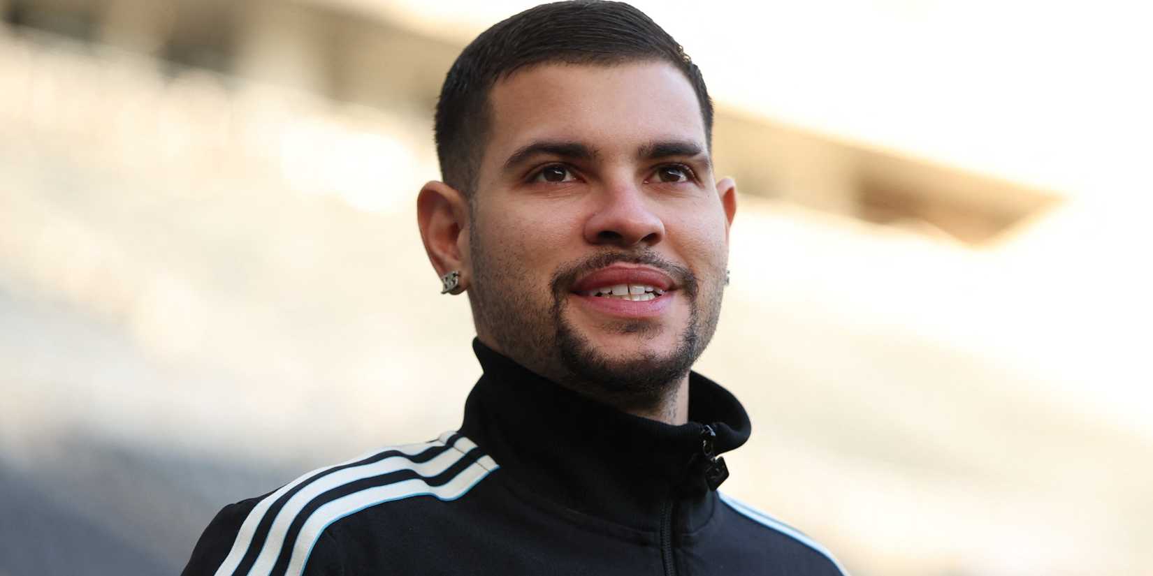 Newcastle United midfielder Bruno Guimaraes smiles as he walks into St James' Park