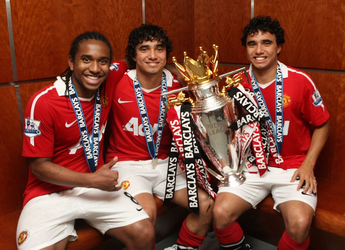 MANCHESTER, ENGLAND - MAY 22:  Anderson, Rafael Da Silva and Fabio Da Silva of Manchester United pose in the dressing room with the Barclays Premier League trophy after the Barclays Premier League match between Manchester United and Blackpool at Old Trafford on May 22, 2011 in Manchester, England.  (Photo by John Peters/Manchester United via Getty Images)