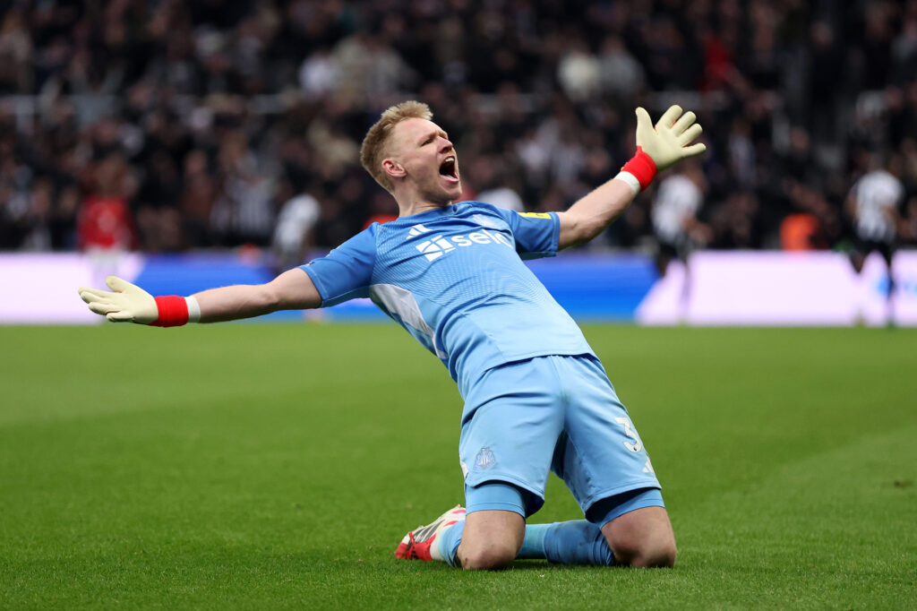 Aaron Ramsdale celebrates with a knee slide after Newcastle United beat Manchester United in the Premier League.
