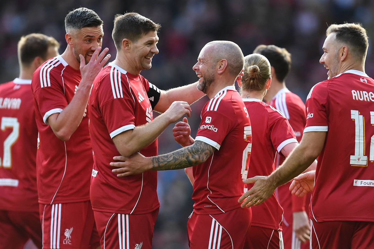 Liverpool Legends' midfielder Jay Spearing (C) celebrates with teammates after scoring during the Legends football match between Liverpool Legends and Dortmund Legends at Anfield in Liverpool, north-west England on March 28, 2026. (Photo by PETER POWELL / AFP via Getty Images)