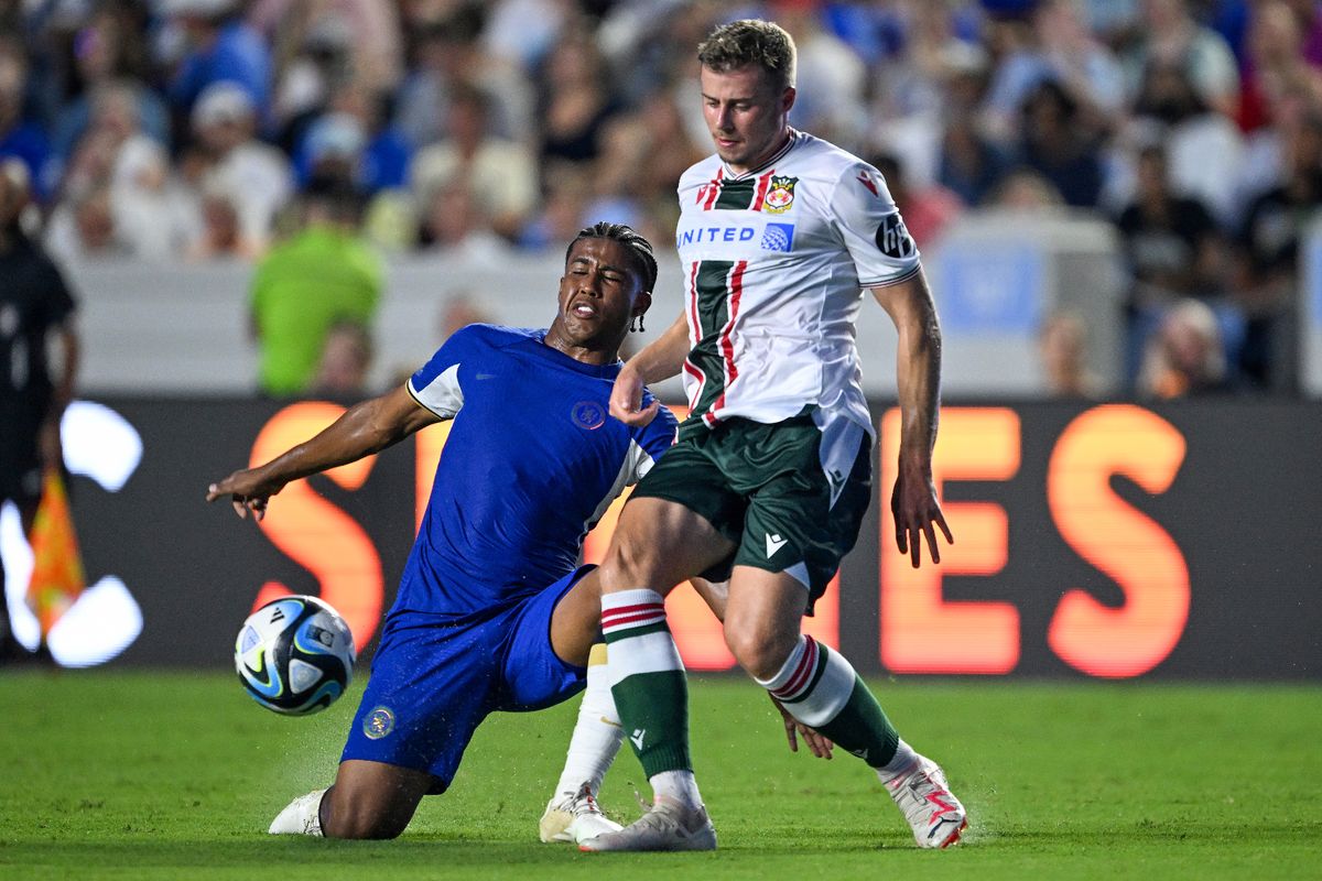 Andrey Santos #39 of Chelsea FC challenges James Jones #30 of Wrexham AFC during the first half of a pre-season friendly match at Kenan Stadium 