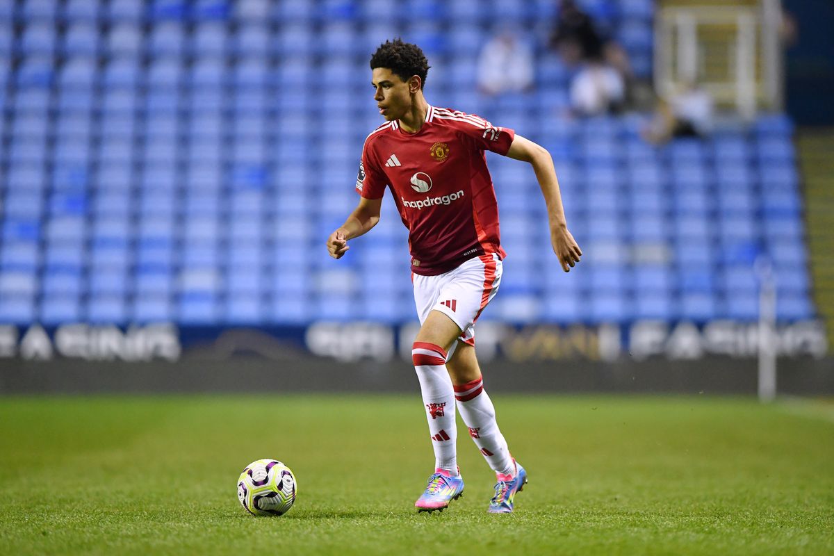 Noah Ajayi of Manchester United runs with the ball during the Premier League 2 match between Reading U21 and Manchester United U21 at Select Car Leasing Stadium on April 11, 2025