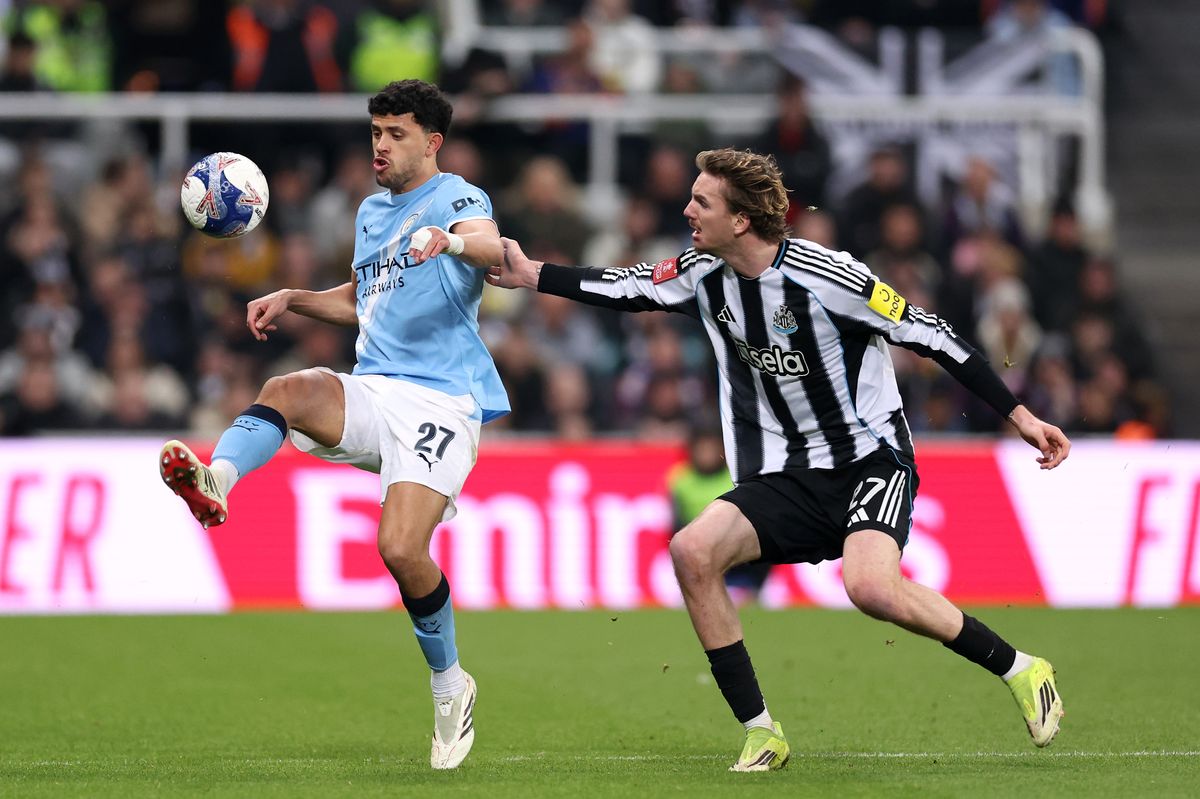 Matheus Nunes of Manchester City controls the ball whilst under pressure from Nick Woltemade of Newcastle United