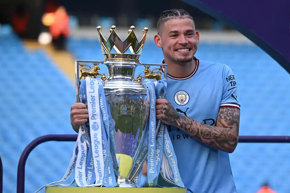 Kalvin Phillips poses with the Premier League trophy