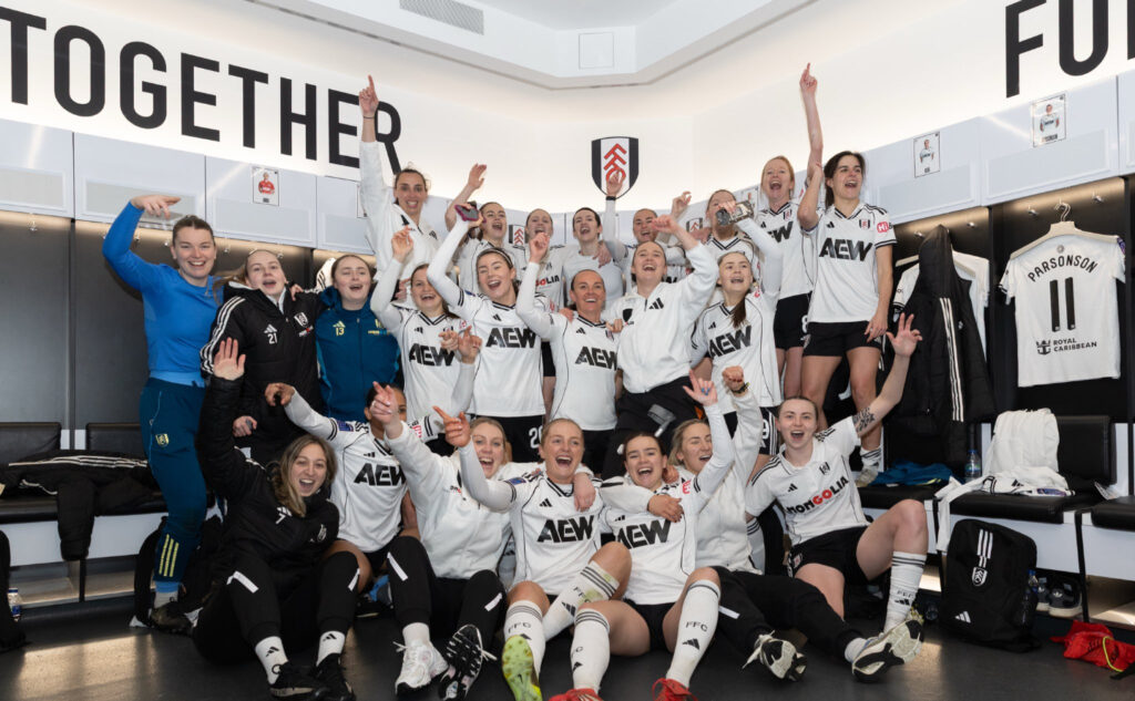 Fulham Women celebrate in the changing room at Craven Cottage
