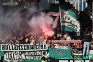 Fans of SC Preussen Münster wave flags during the 2. Bundesliga match between SC Preußen Münster and Hertha BSC