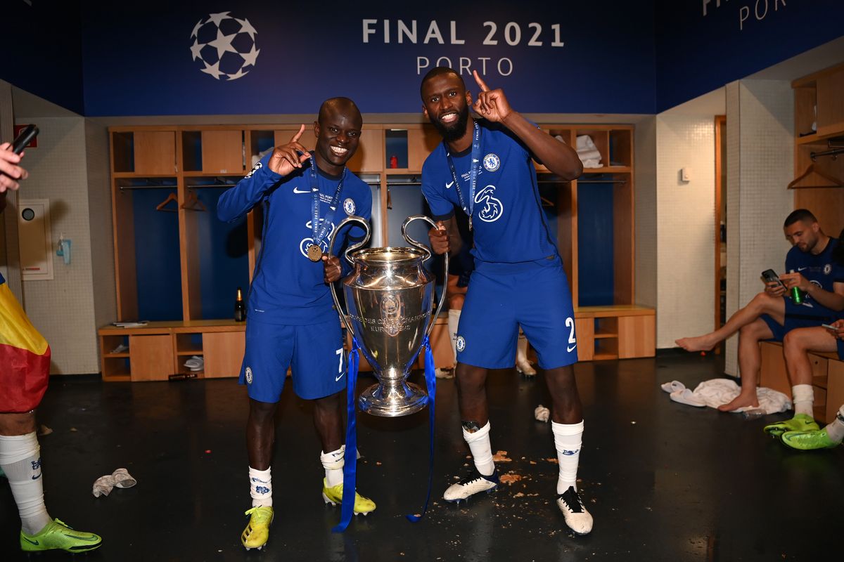 N'Golo Kante (L) and Antonio Rudiger of Chelsea pose in the dressing room with the Champions League Trophy following their team's victory in the UEFA Champions League Final between Manchester City and Chelsea FC