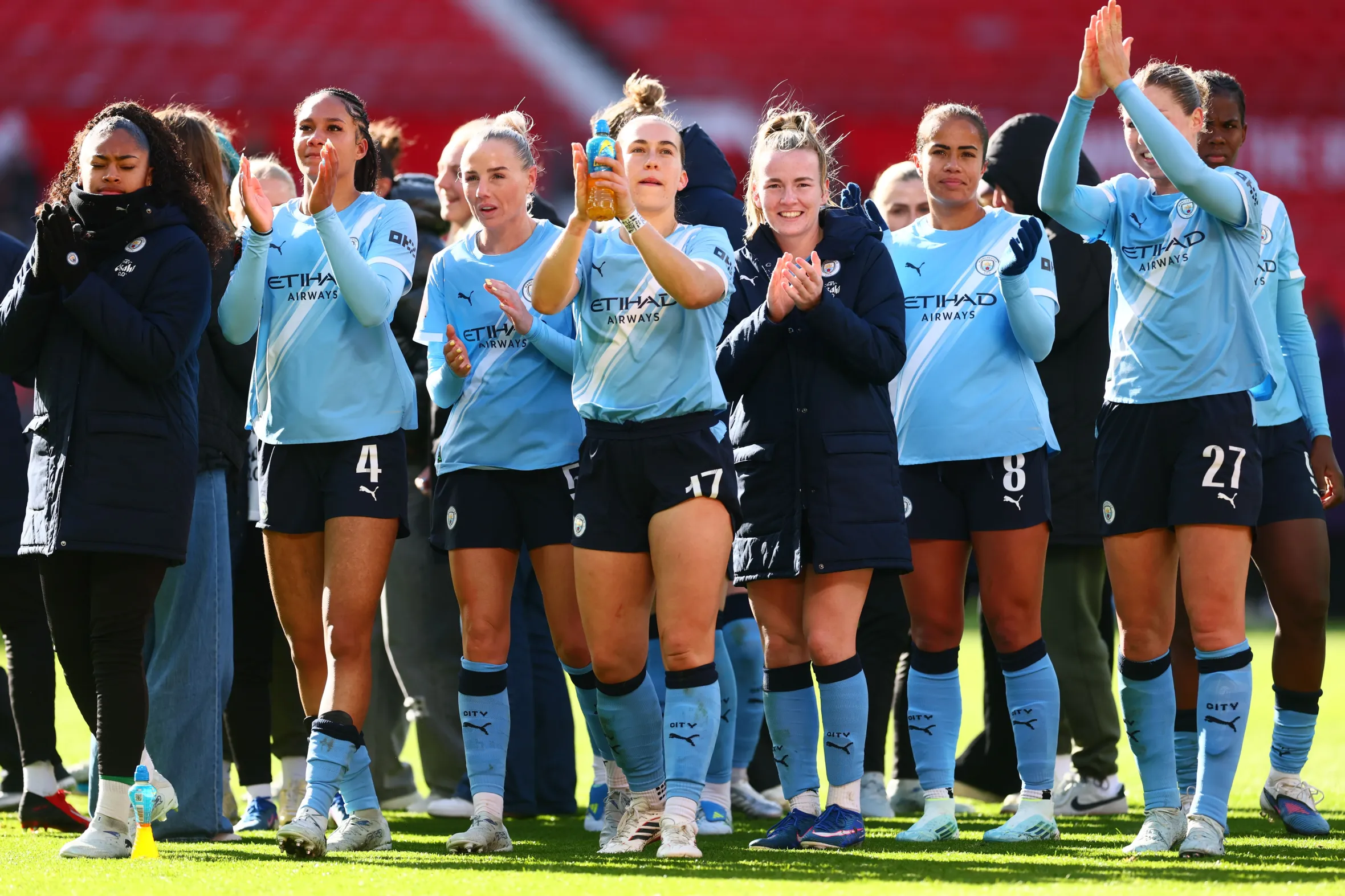 Manchester City players including Sam Coffey and Lauren Hemp celebrate at the end of the match.
