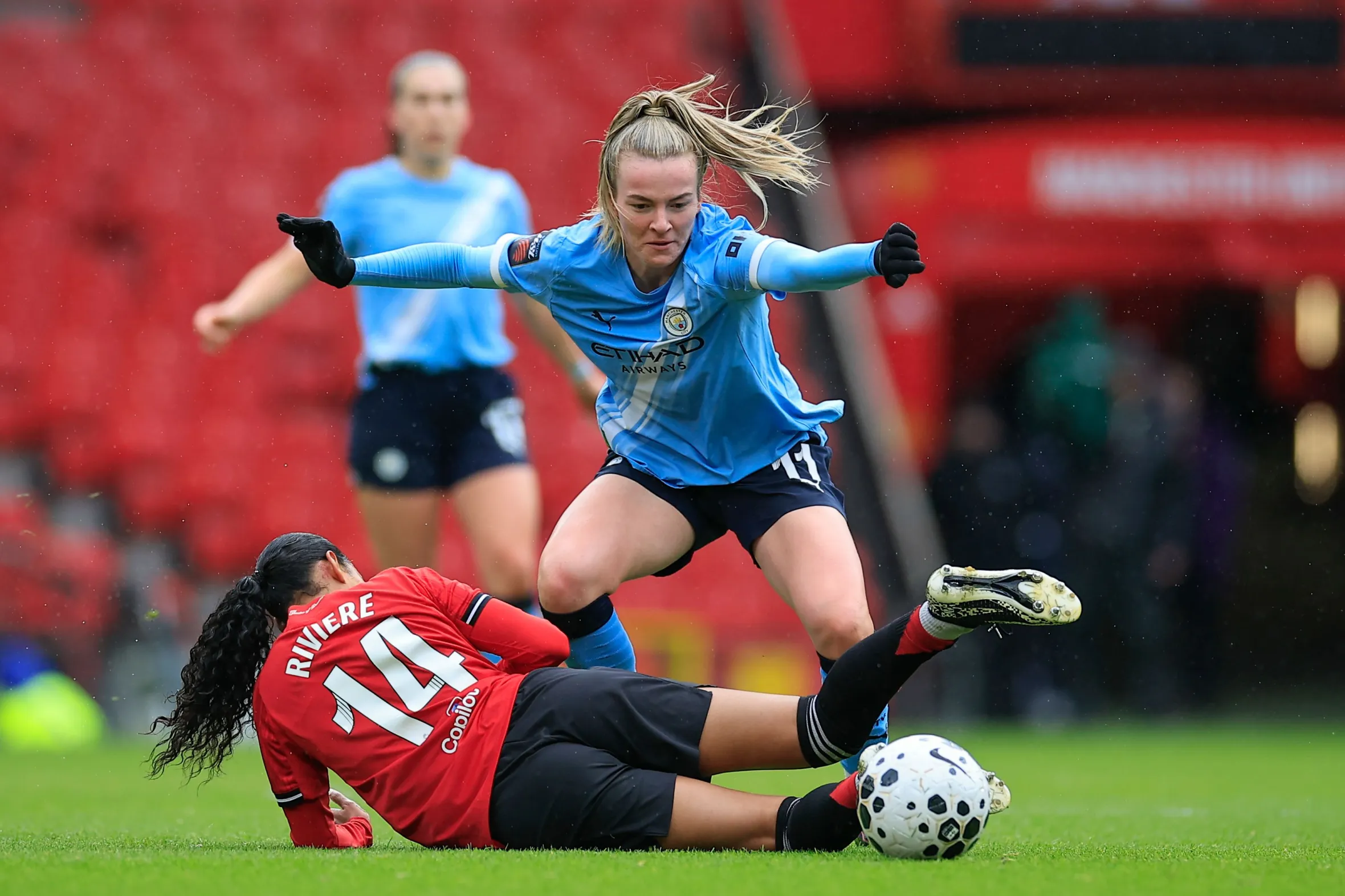 Lauren Hemp of Manchester City challenging Jayde Riviere of Manchester United during a Women's Super League match.
