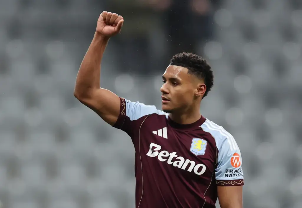 Ollie Watkins raises his fist to the Aston Villa fans at the end of a game to celebrate a win