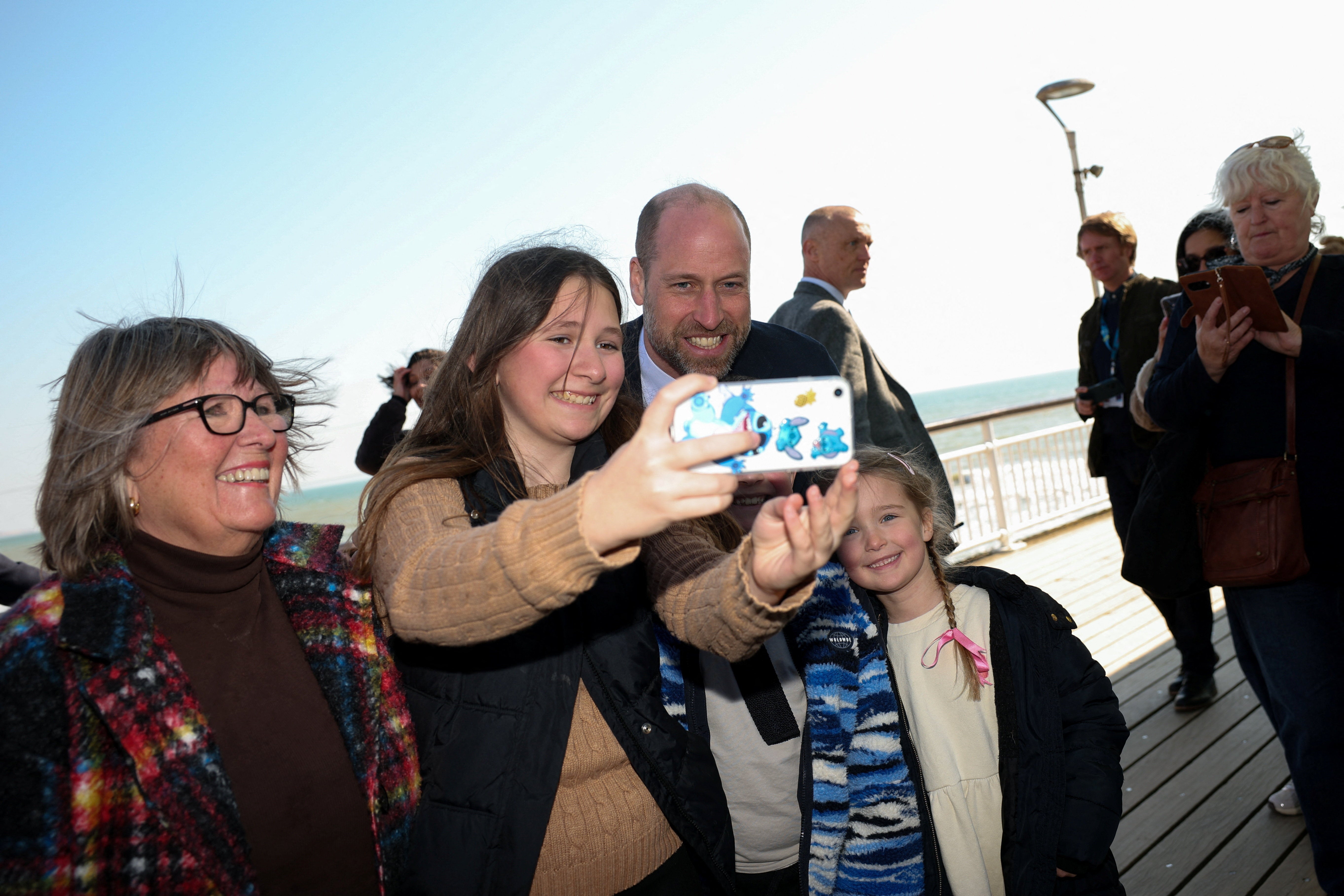 William, Prince of Wales, poses for a selfie with people, during a Homewards visit on its prevention-focused approach to youth homelessness in Bournemouth, Christchurch and Poole (BCP)