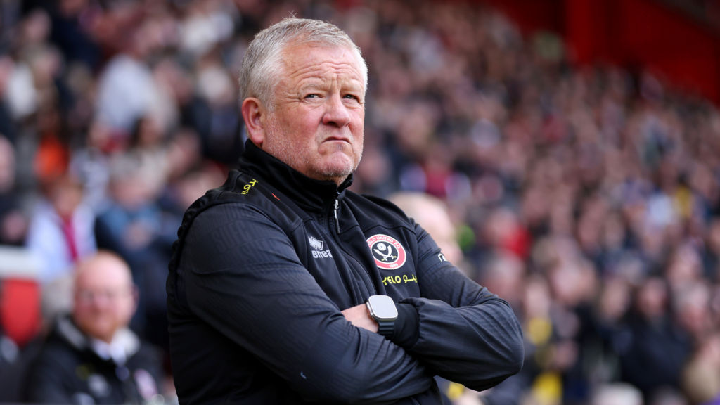 Sheffield United manager Chris Wilder stands with his arms folded on the touchline.