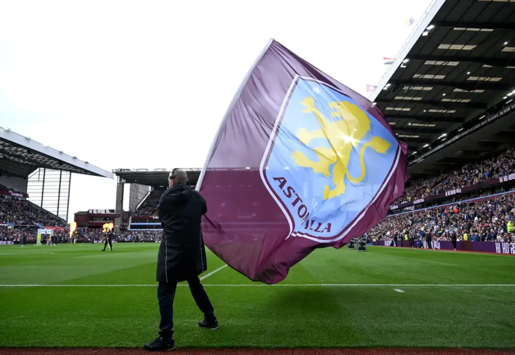 An Aston Villa flag bearer waves an Aston Villa flag before a game at Villa Park