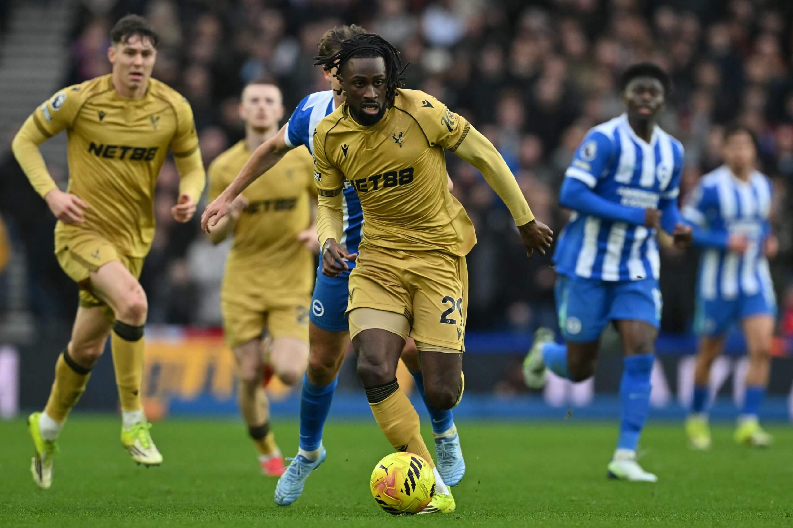 Evann Guessand drives forward in possession at Brighton