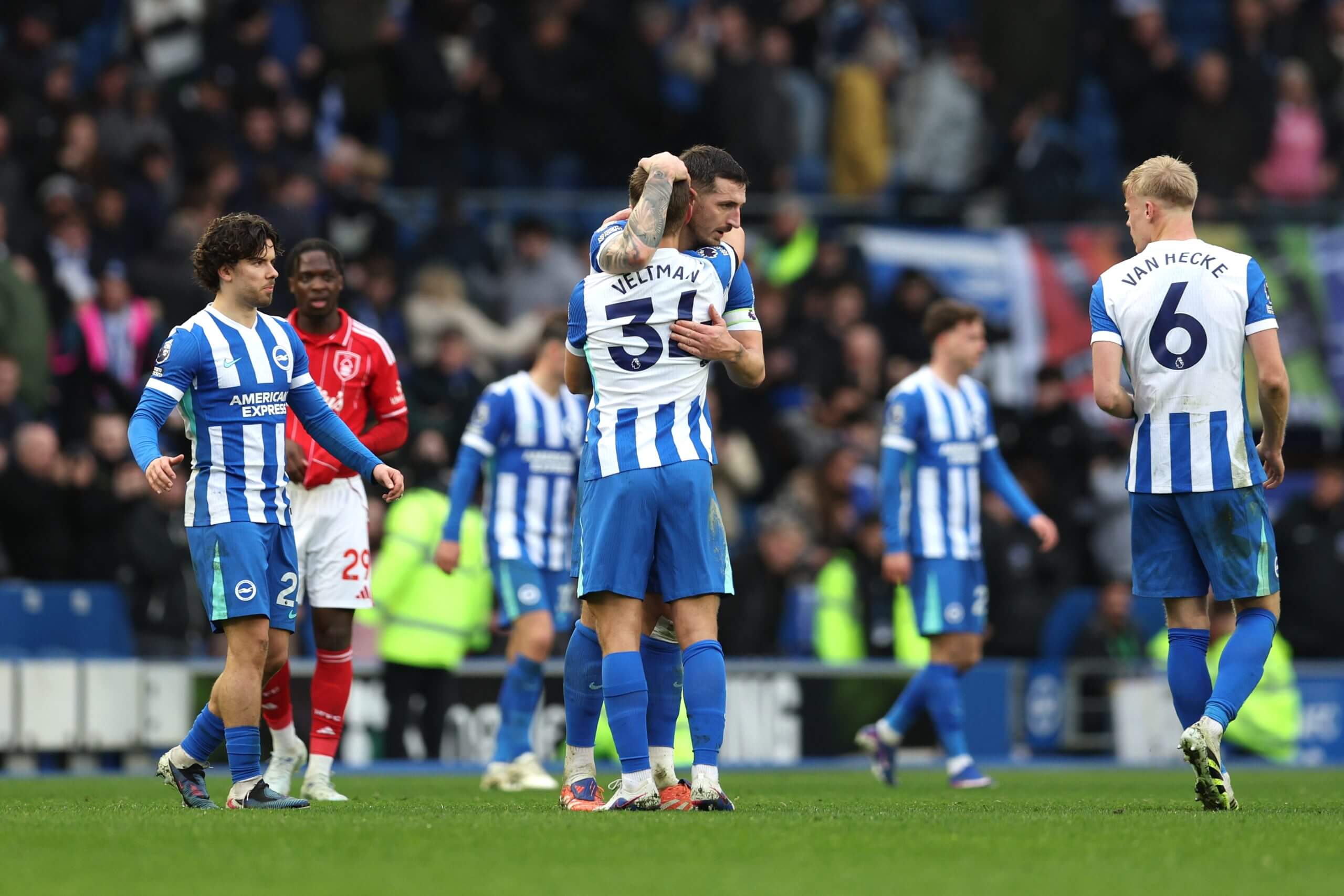 Lewis Dunk hugs team-mate Joel Veltman after the final whistle