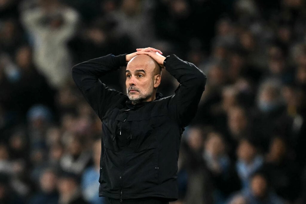 Pep Guardiola looking dejected during a Manchester City game