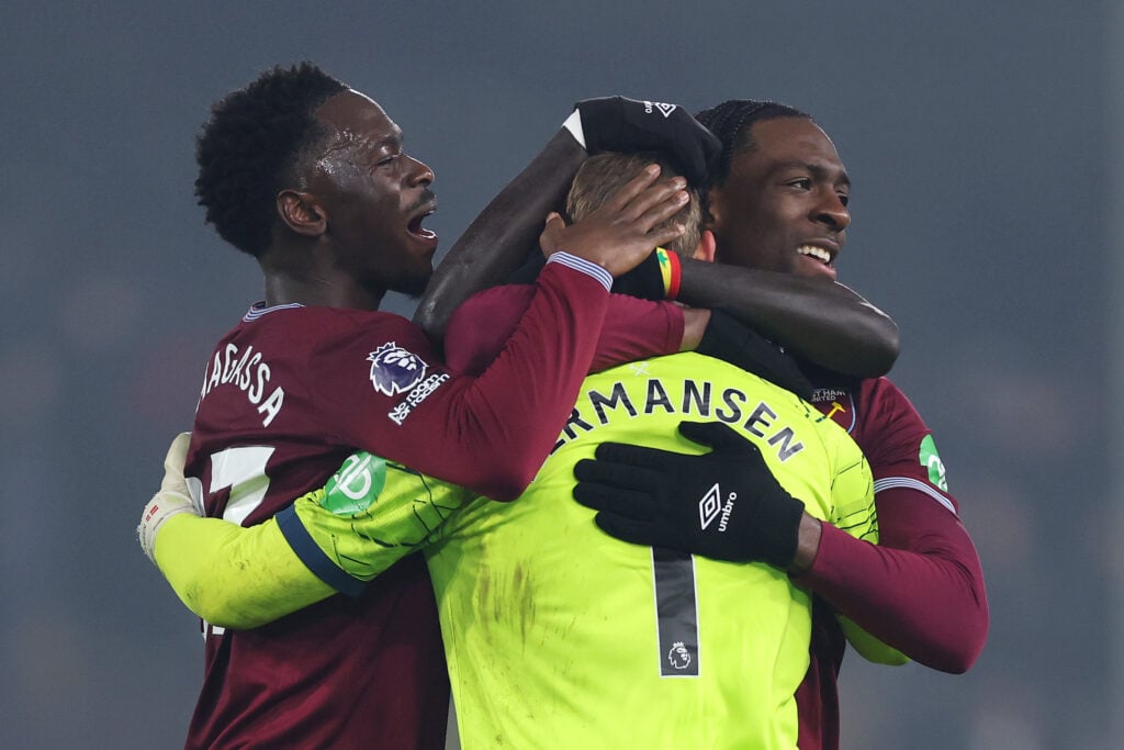 Soungoutou Magassa and Aexl Disasi hug Mads Hermansen after West Ham United beat Fulham in the Premier League.