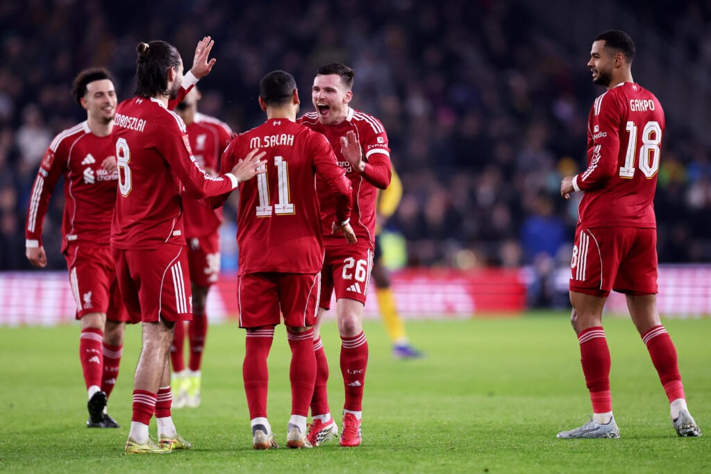 Mohamed Salah of Liverpool celebrates scoring his team's second goal with teammate Dominik Szoboszlai and Andrew Robertson during the Emirates FA Cup Fifth Round match between Wolverhampton Wanderers and Liverpool