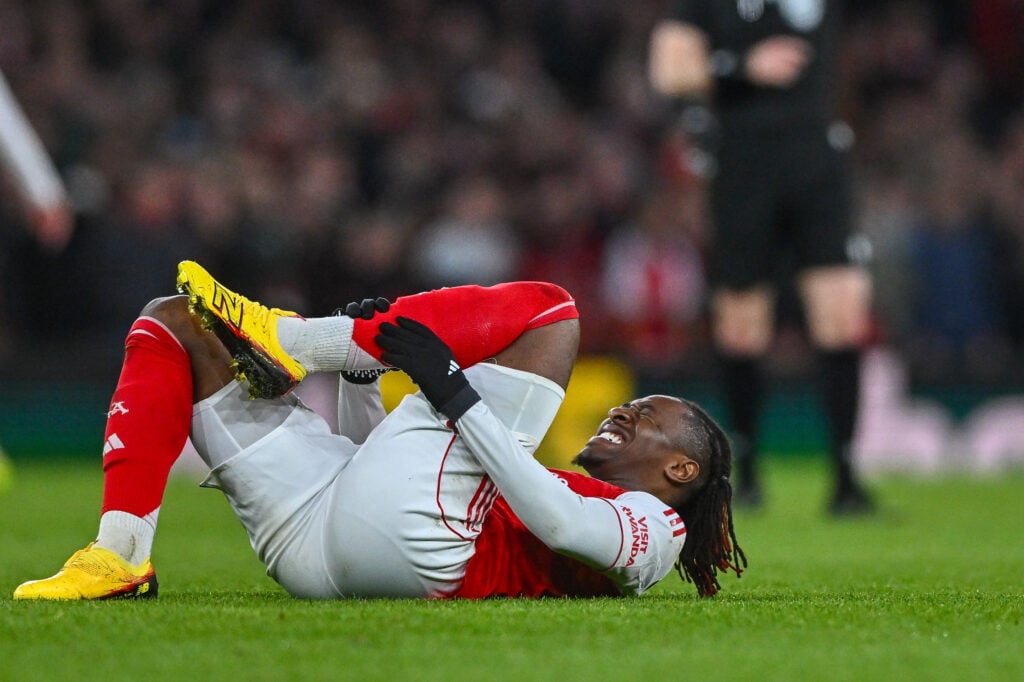 Eberechi Eze of Arsenal FC injured on the ground during the UEFA Champions League 2025/26 Round of 16 Second Leg match between Arsenal FC and Bayer 04 Leverkusen at Arsenal Stadium.