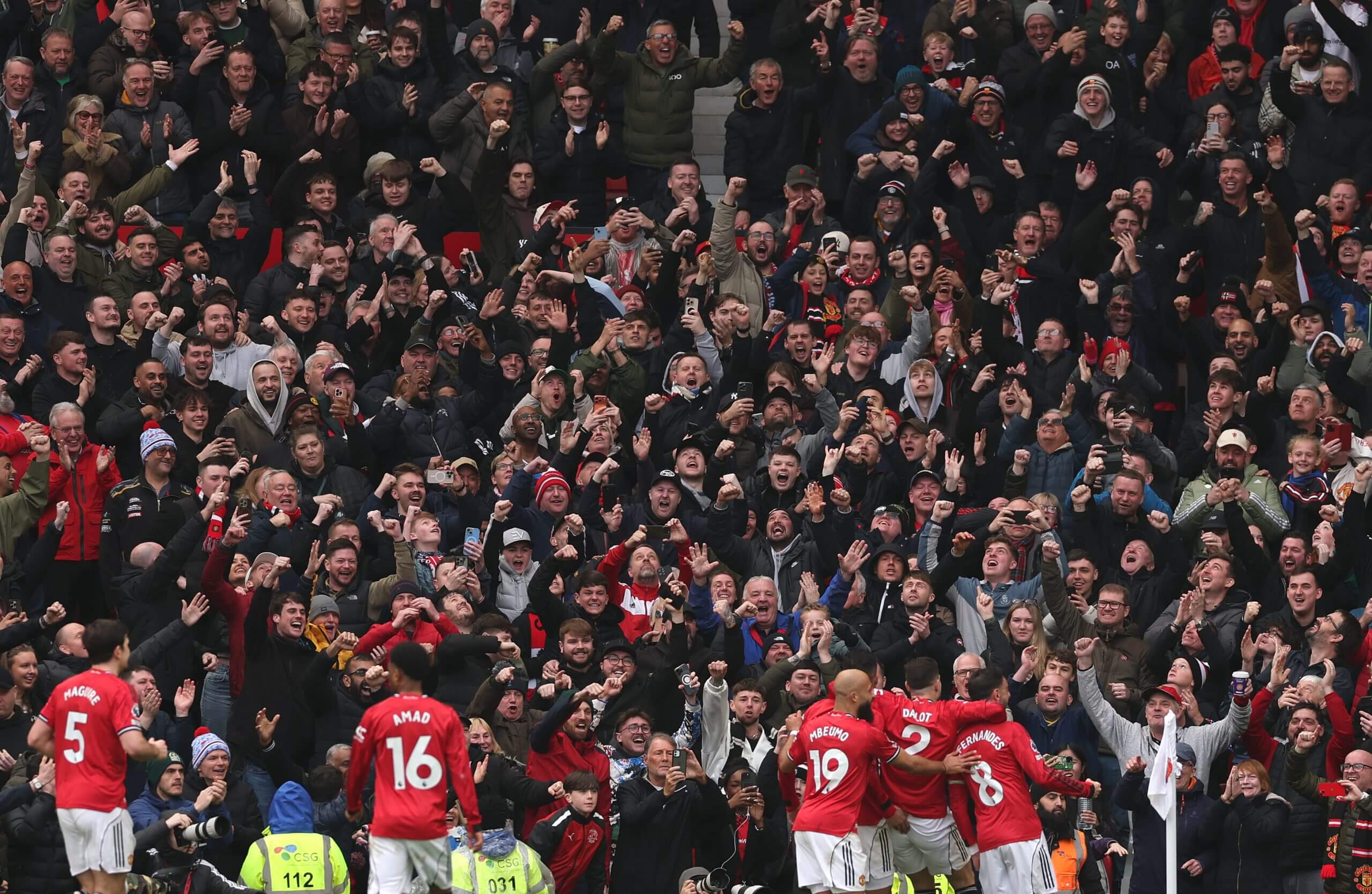 Bruno Fernandes of Manchester United and team-mates celebrate the second goal in front of the Manchester United fans